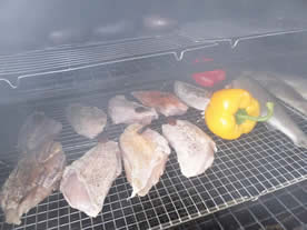 chicken and trout on a barrel smoker